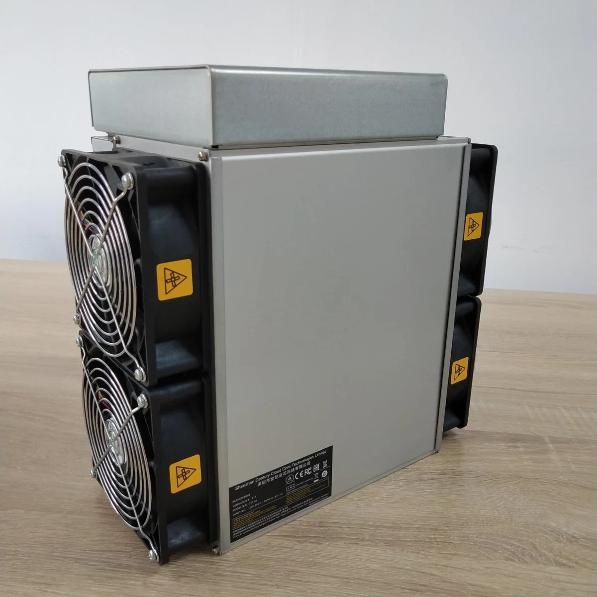 Rectangular silver metal mining unit with four front fans and improved heatsink visible