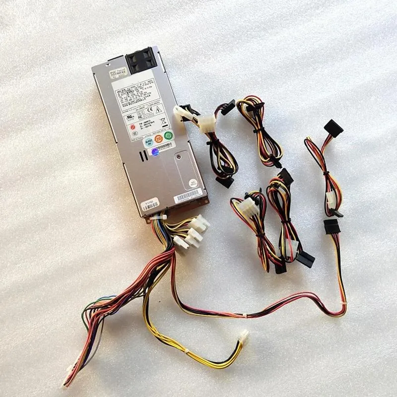 Compact silver 1U power supply with rear fan grille and modular cables