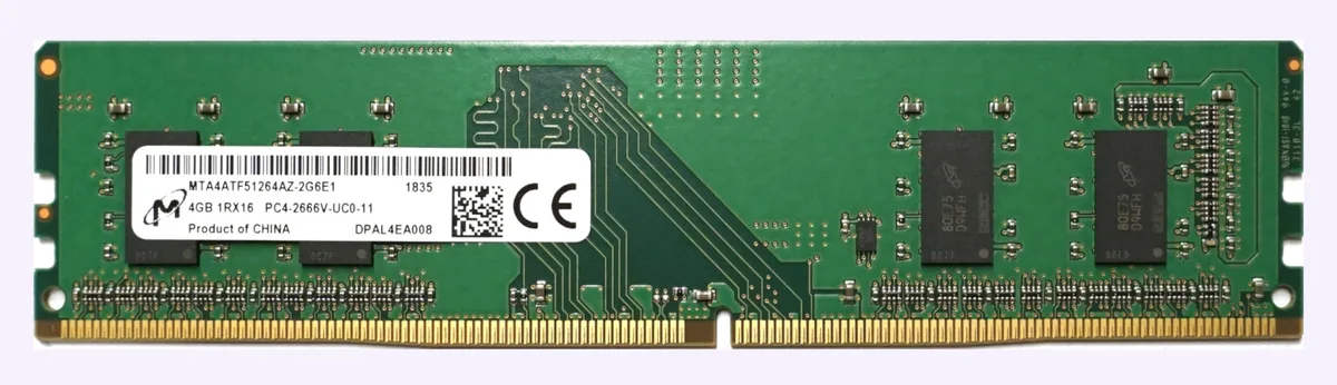 Green rectangular circuit board with gold edge connectors and black memory chips