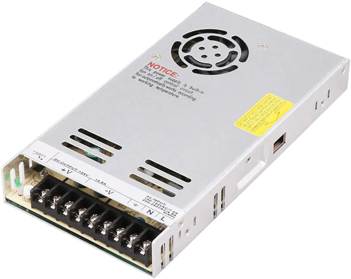 Rectangular silver metal power supply unit with ventilation slots and terminal connections