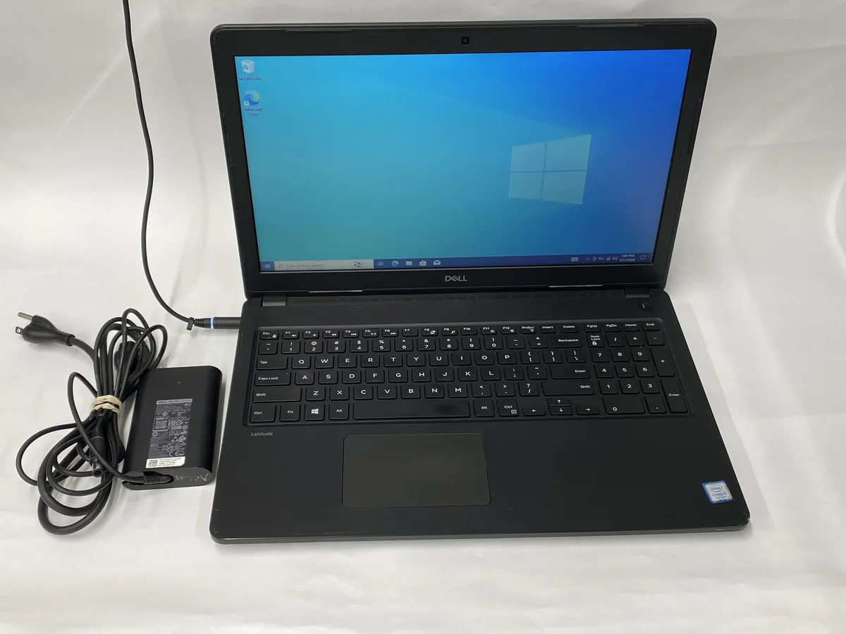 Silver Dell Latitude 3580 laptop, 15 inch screen, visible scratches on lid and base