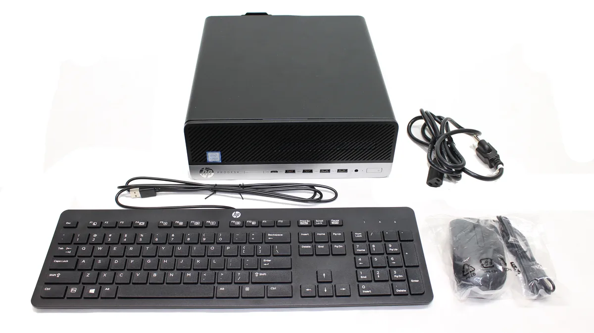 Small silver rectangular tower with front USB ports and DVD slot