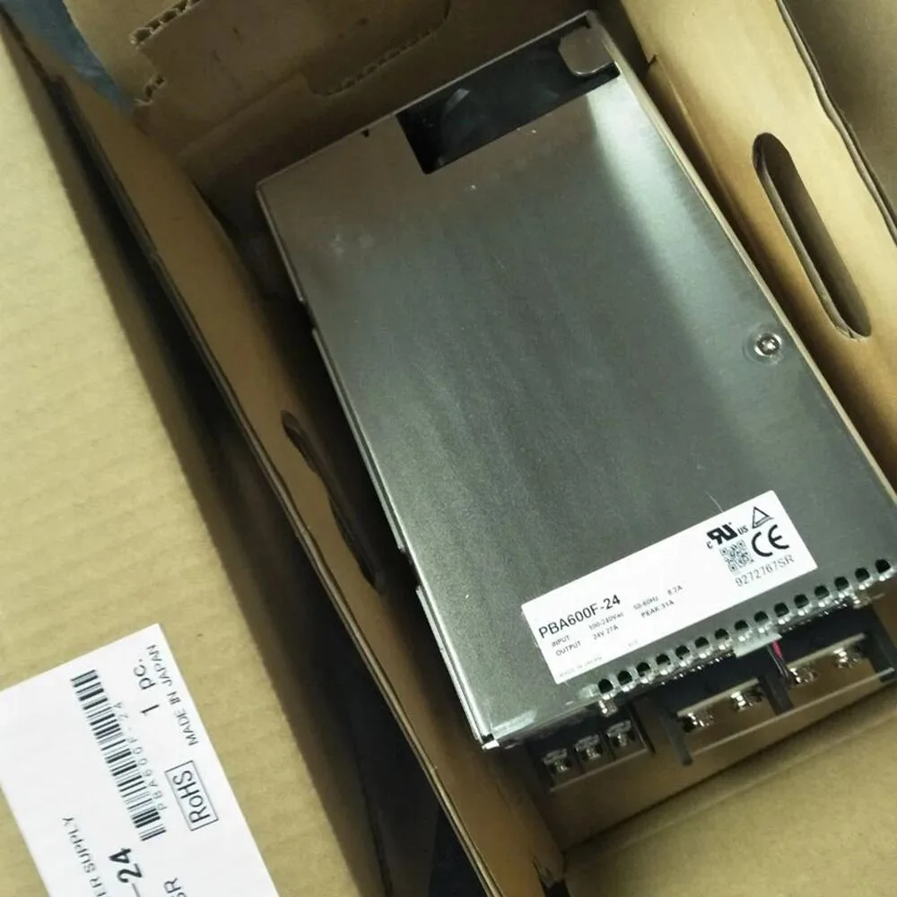 Silver rectangular ATX power supply unit with ventilation grille and label showing 600 W 24 V specifications