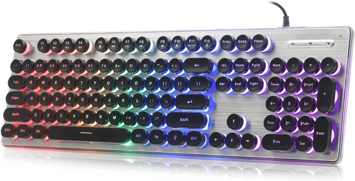 Full-size keyboard with round floating keycaps, brushed silver metal panel, black chassis, rainbow backlighting, USB cable attached