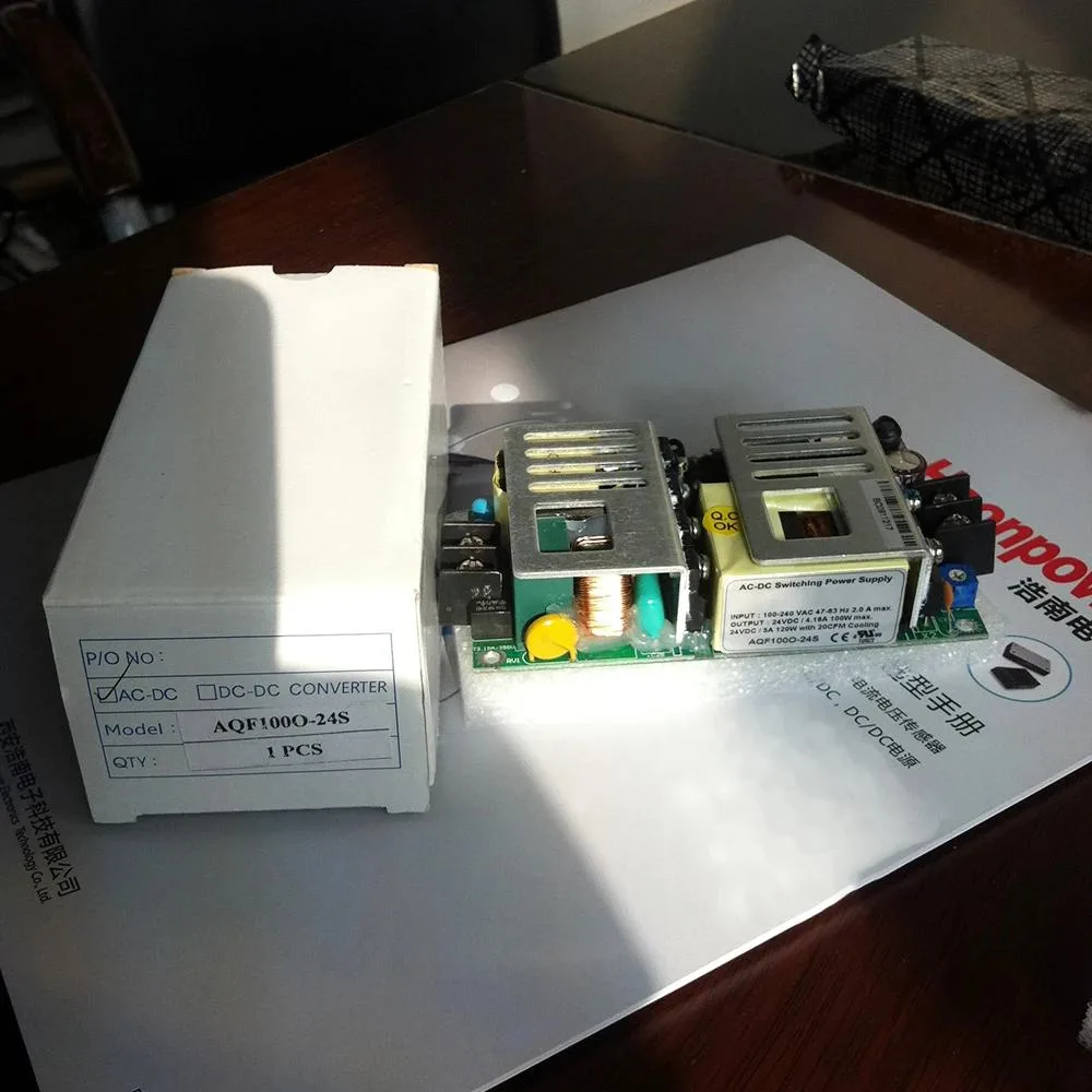 Rectangular metal power supply unit with ventilation slots and terminal connectors