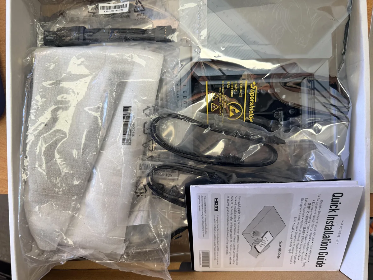 ATX motherboard dark finish silver heatsinks four DDR5 slots