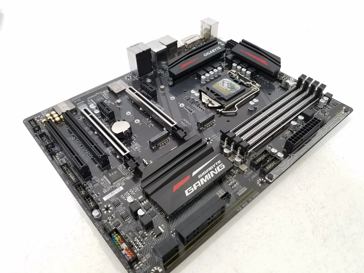 ATX motherboard with black PCB, silver heatsinks and LGA 1151 socket