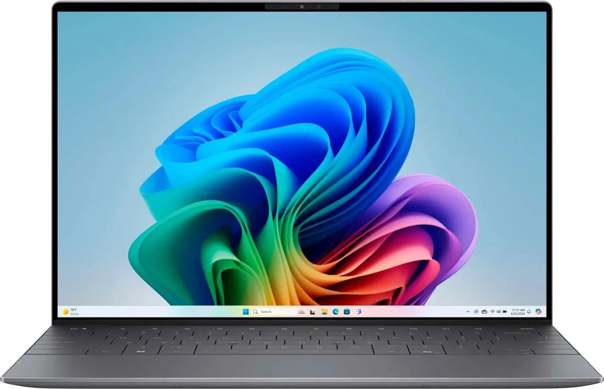 Thin graphite laptop with 13.4 inch OLED touchscreen open on desk