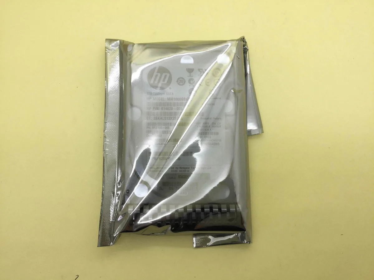 Silver rectangular 2.5 inch SATA hard drive with label showing 1TB 7200RPM