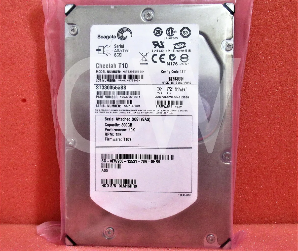 Silver 3.5 inch SAS hard drive with label showing DELL FW956 300GB 15000RPM