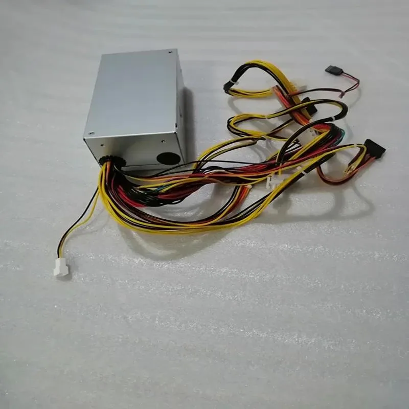 Silver ATX power supply unit with fan grille and cable bundle