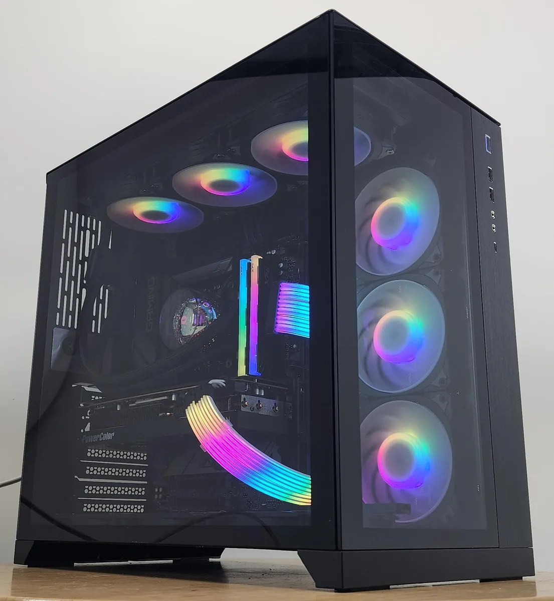 Black Lian Li O11 Dynamic ATX case with 360mm AIO RGB cooler and RX 7800 XT graphics card visible through tempered glass side panel