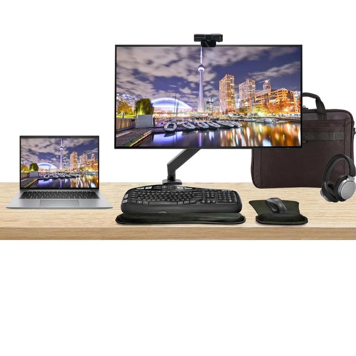 Silver 14 inch laptop, 32 inch 4K monitor on desk mount, wireless keyboard, mouse, webcam, headphones, briefcase