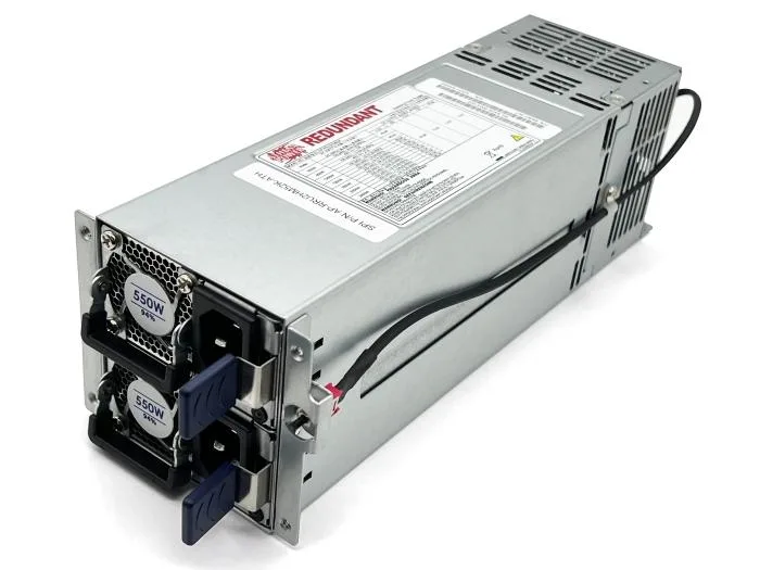 Silver metal 2U server power supply unit with dual 550W modules, front handle and rear fan grille