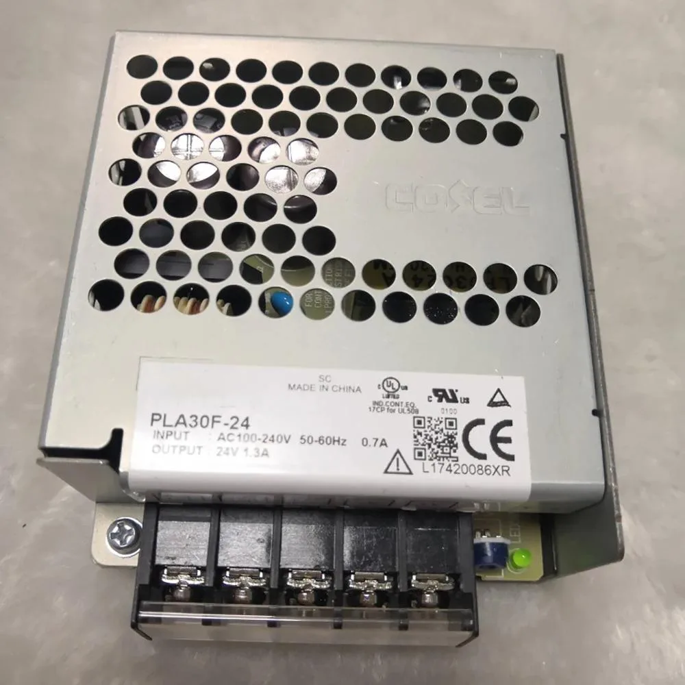 Rectangular metal power supply unit with label showing input and output ratings