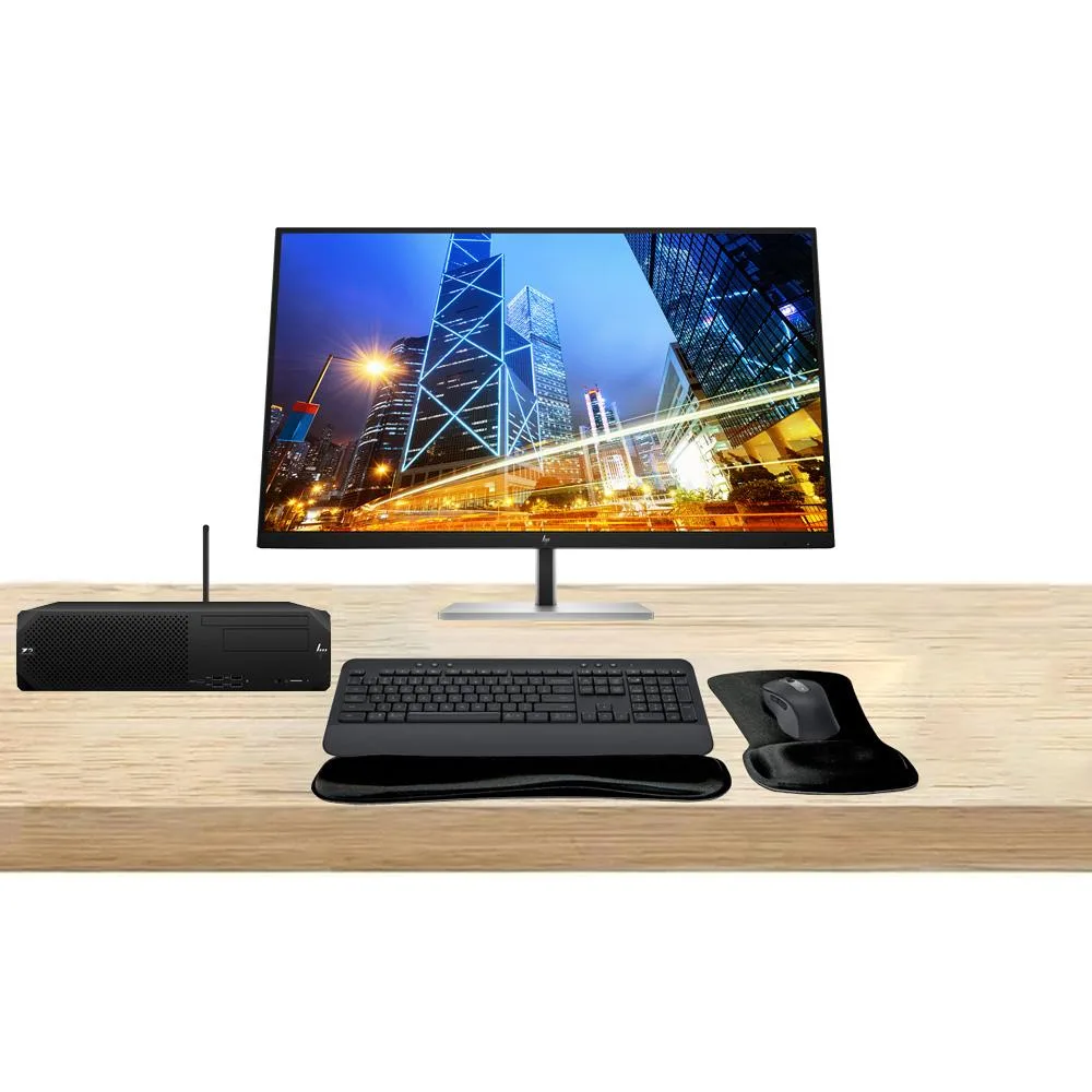 Compact silver mini-tower workstation beside two 32-inch 4K monitors, wireless keyboard with gel wrist rest, vertical mouse