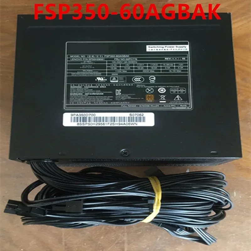 Silver rectangular ATX power supply with gold badge and black fan grille