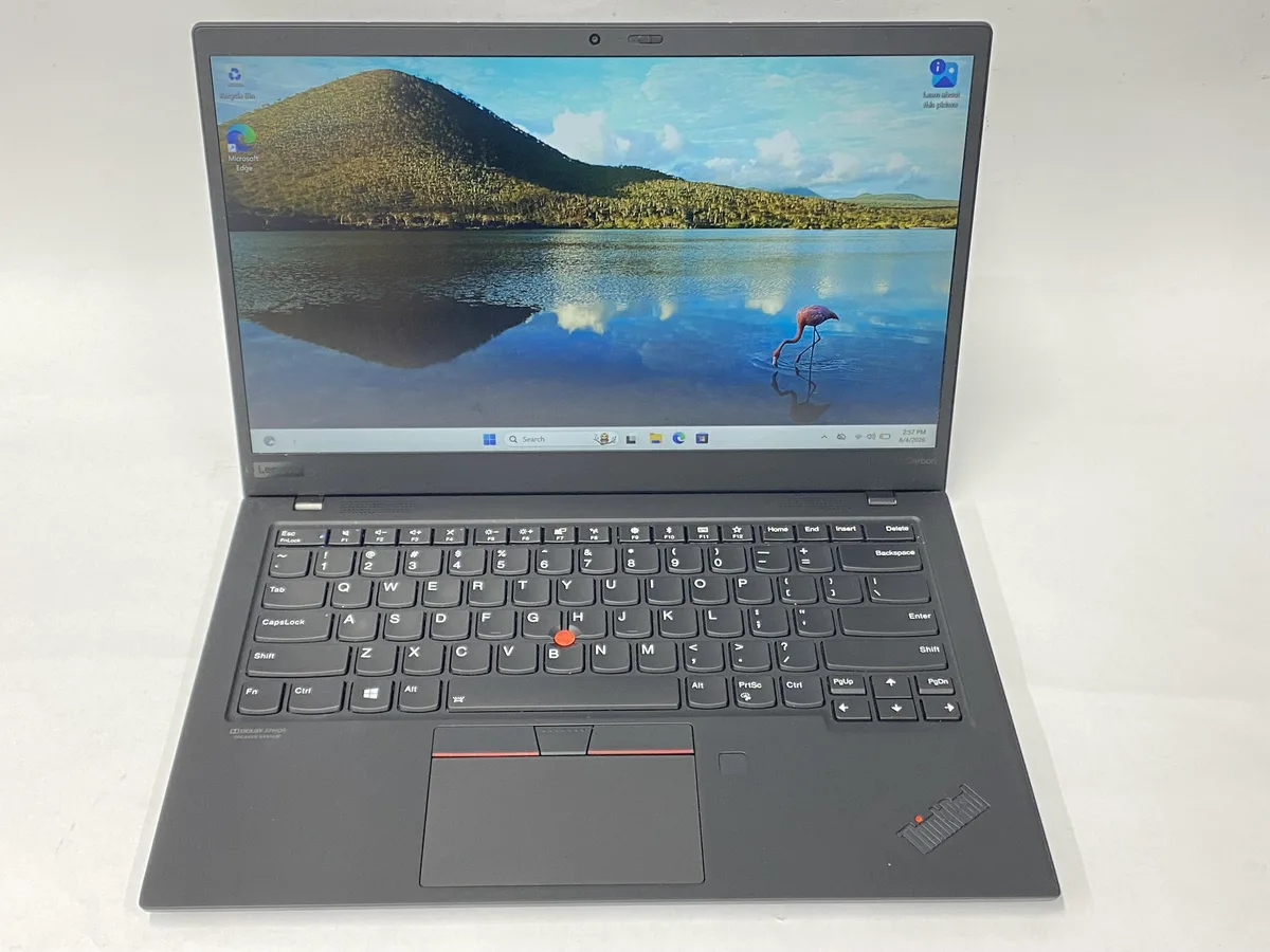 Slim matte-black 14-inch laptop with non-touch 1920 by 1080 screen and charger