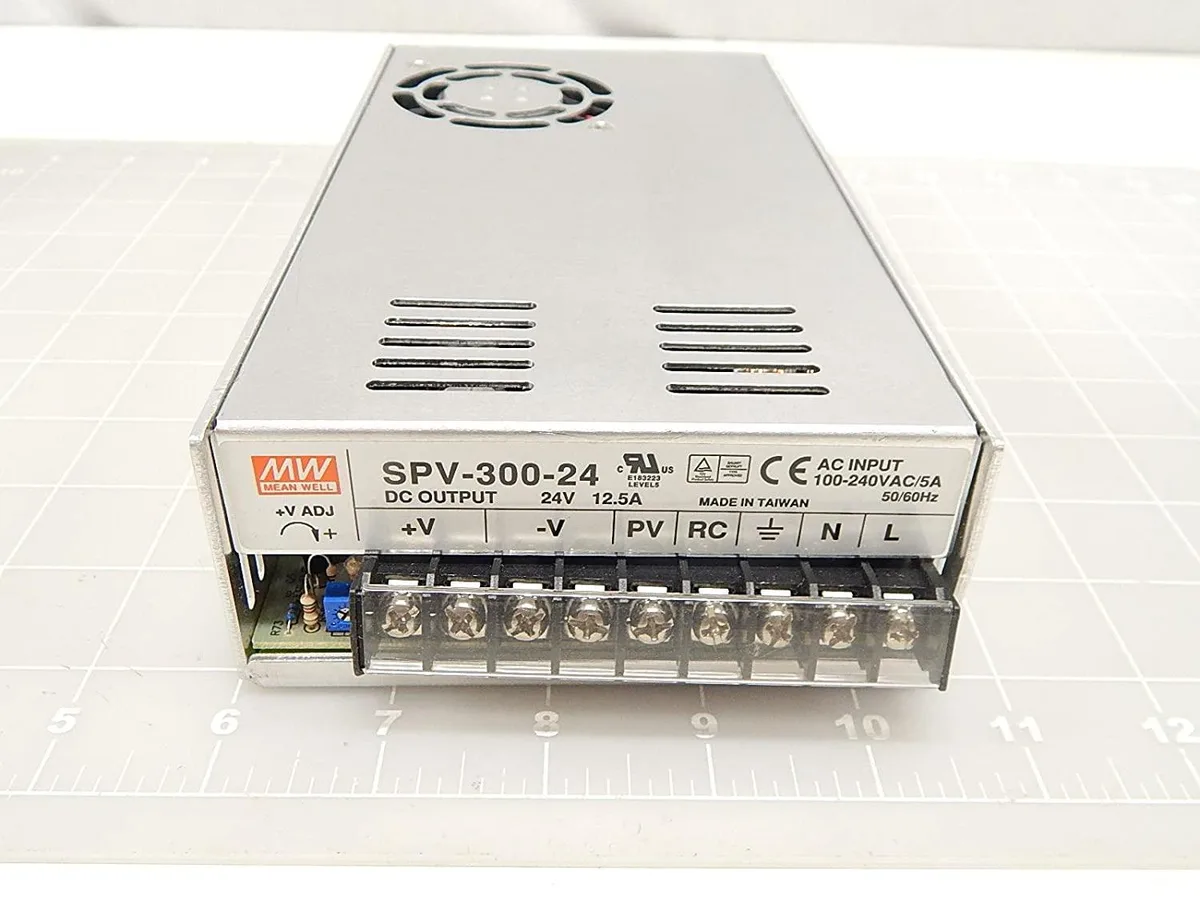 Rectangular metal power supply unit with built-in fan and ventilation grilles