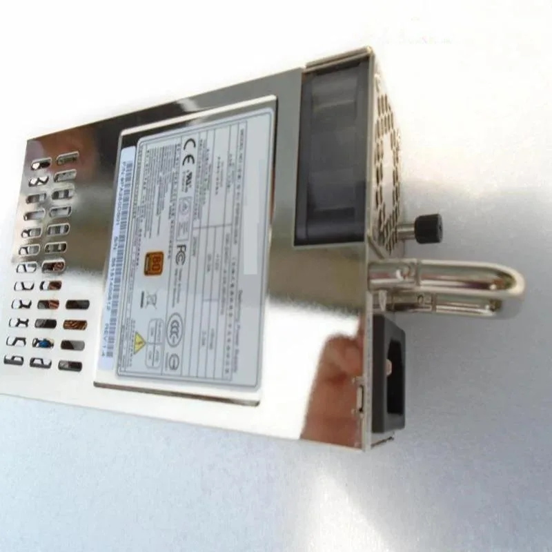 Silver ATX power supply unit with rear fan grille and cable bundle