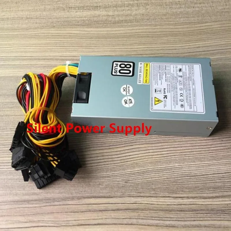 Compact silver 1U power supply with black fan grille and cable bundle