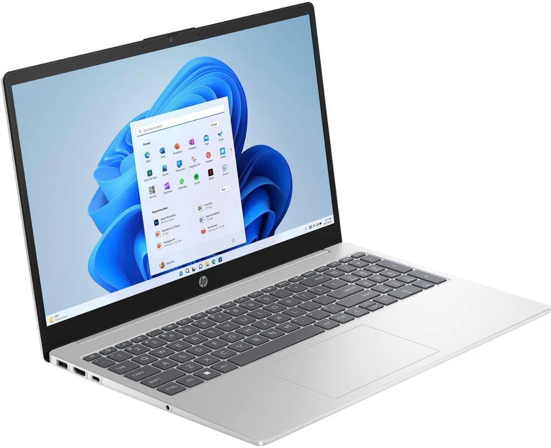 A silver laptop with a 15.6 inch touchscreen display closed on a plain background