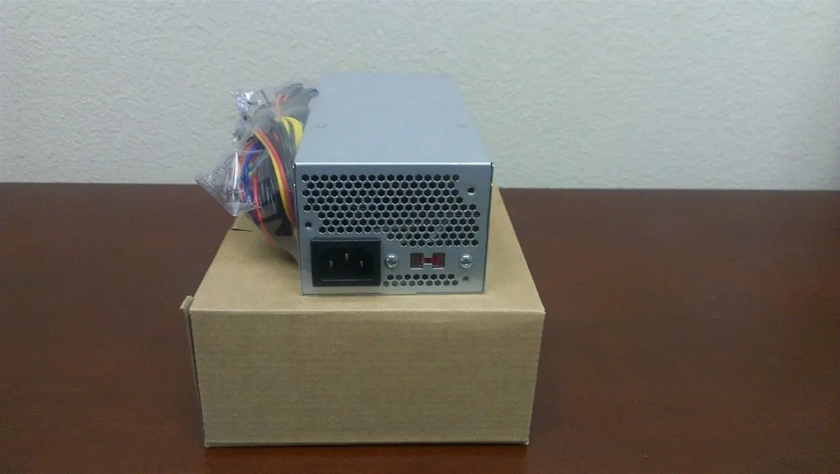 Compact TFX power supply unit with metal casing and 80mm fan visible