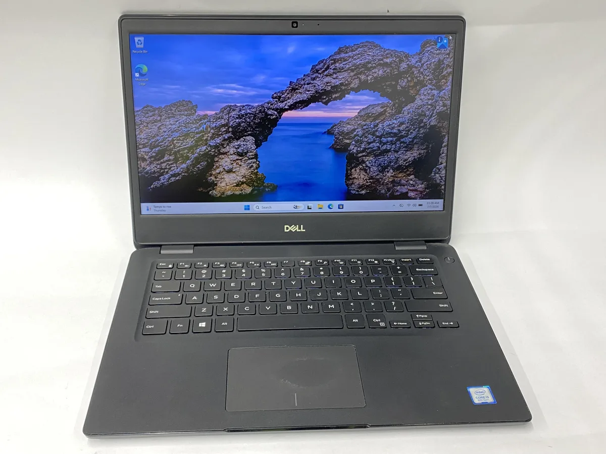 Silver Dell Latitude 3400 14 inch laptop closed on desk