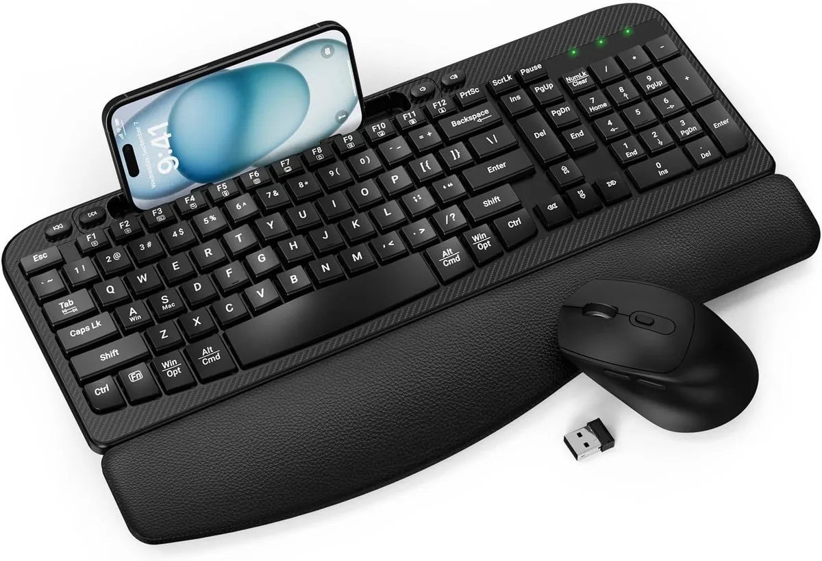 Black full-size wireless keyboard with wave-shaped keys, curved leather palm rest, 7.28in phone slot, matching mouse