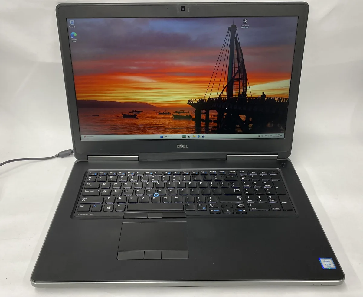 Silver Dell Precision 7720 laptop closed showing lid scratches and scuffs