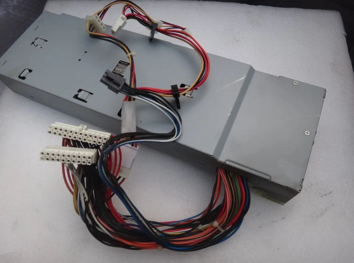 Silver metal rectangular ATX power supply unit with rear fan grille and side label