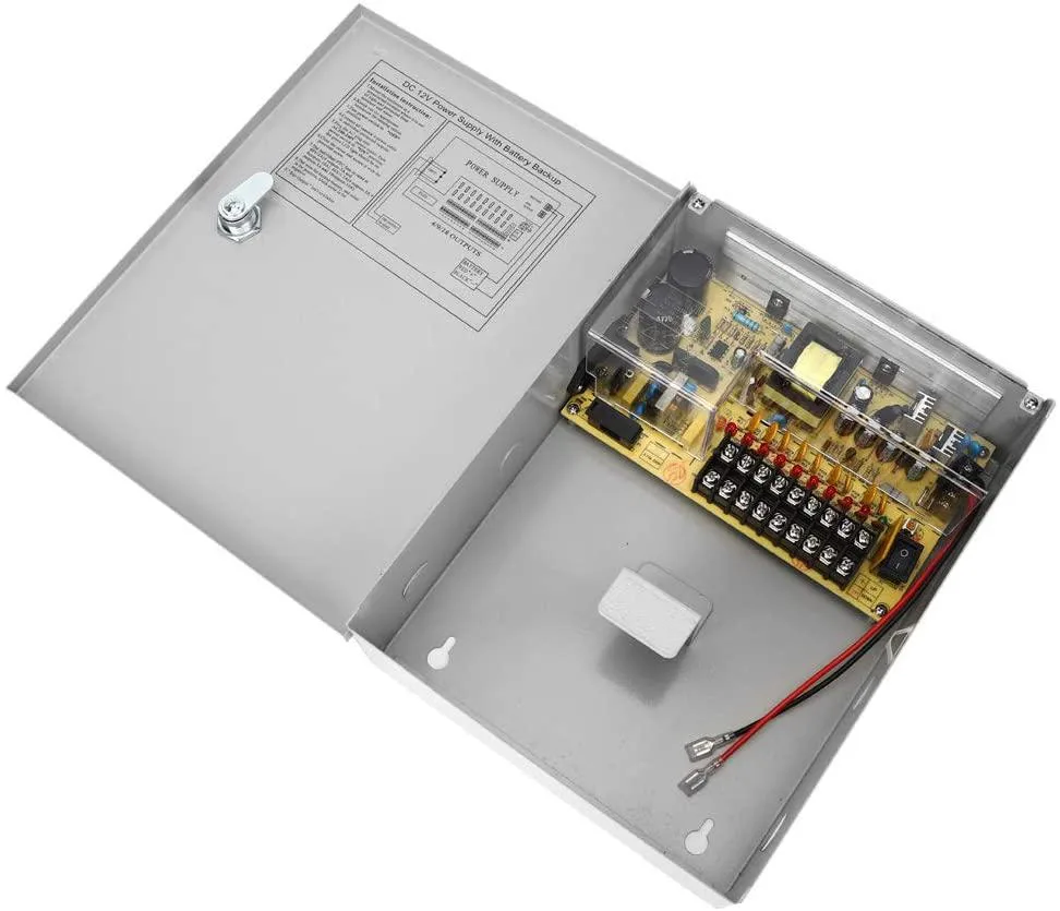 Rectangular metal enclosure with vertical mounting tabs and nine output terminals