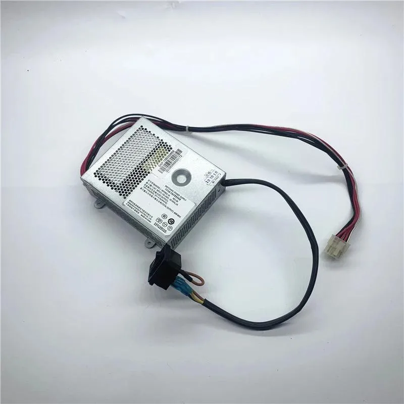 Compact ATX power supply unit in black metal casing with visible cooling fan and cable bundle