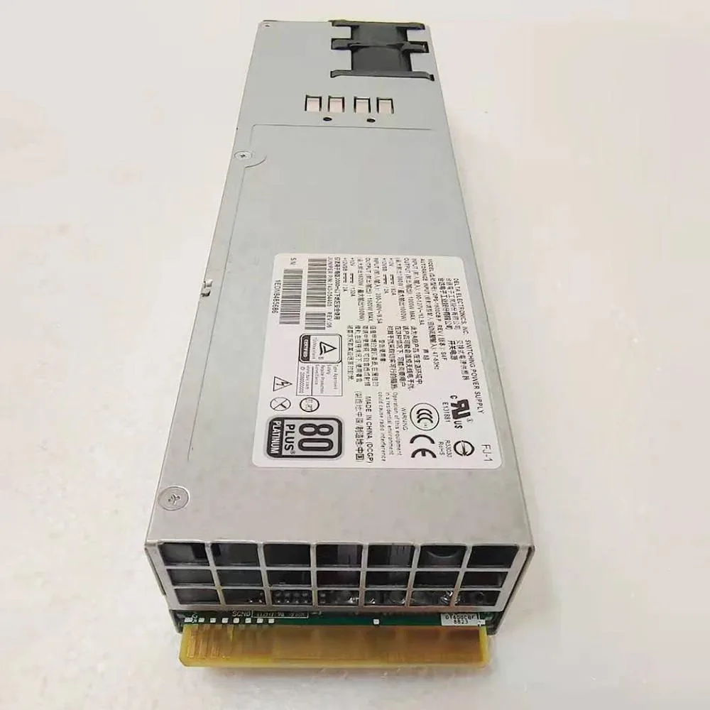 Silver rectangular ATX power supply unit with ventilation grille and label showing 740-054405 QFX10002 1600W