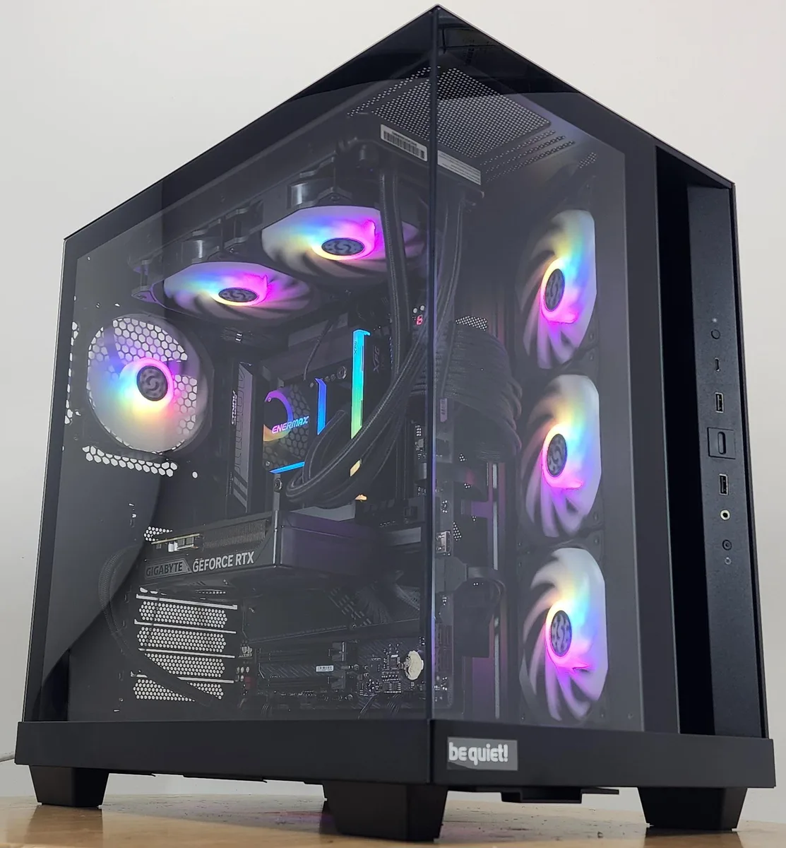 A black mid-tower case with RGB-lit AIO cooler and graphics card visible through tempered glass side panel
