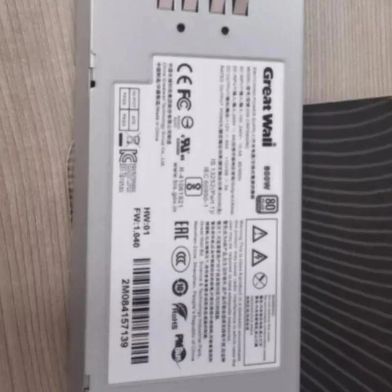 Rectangular silver ATX power supply unit with fan grille and modular connectors visible