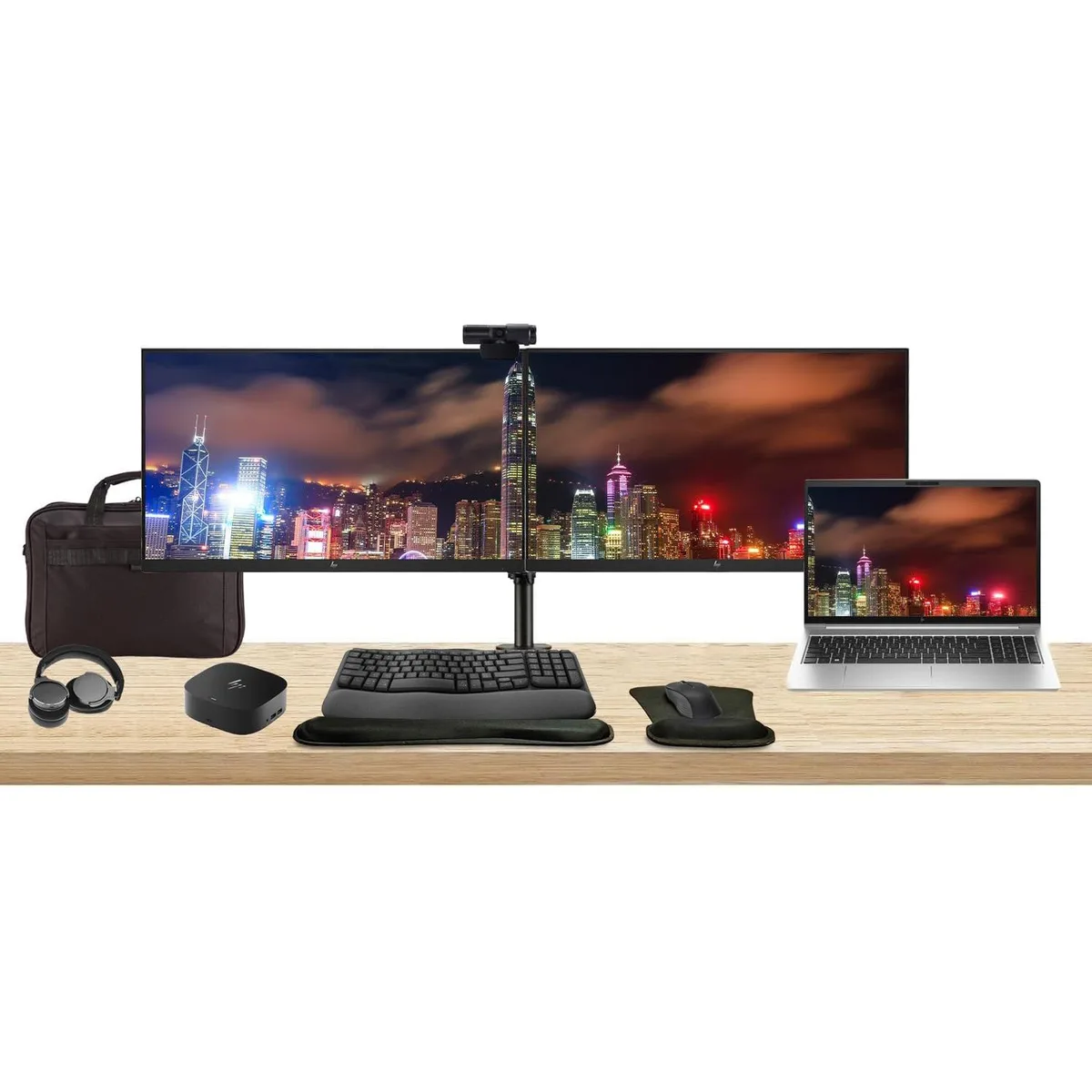 Silver HP ProBook 450 G10 laptop open beside two 24 inch monitors on a dual stand, USB-C dock, wireless keyboard, mouse, webcam