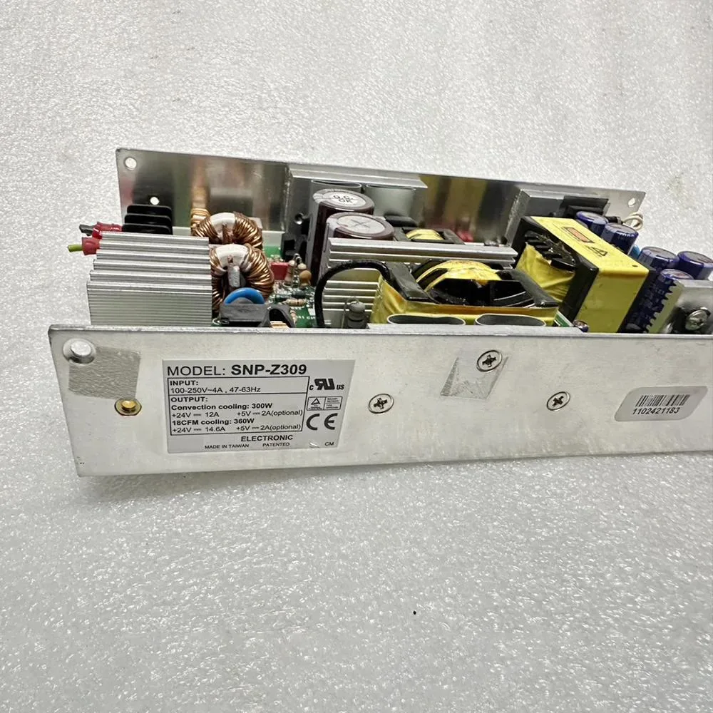 Silver industrial ATX power supply unit rectangular box with label showing 24V 12.5A 5V2A