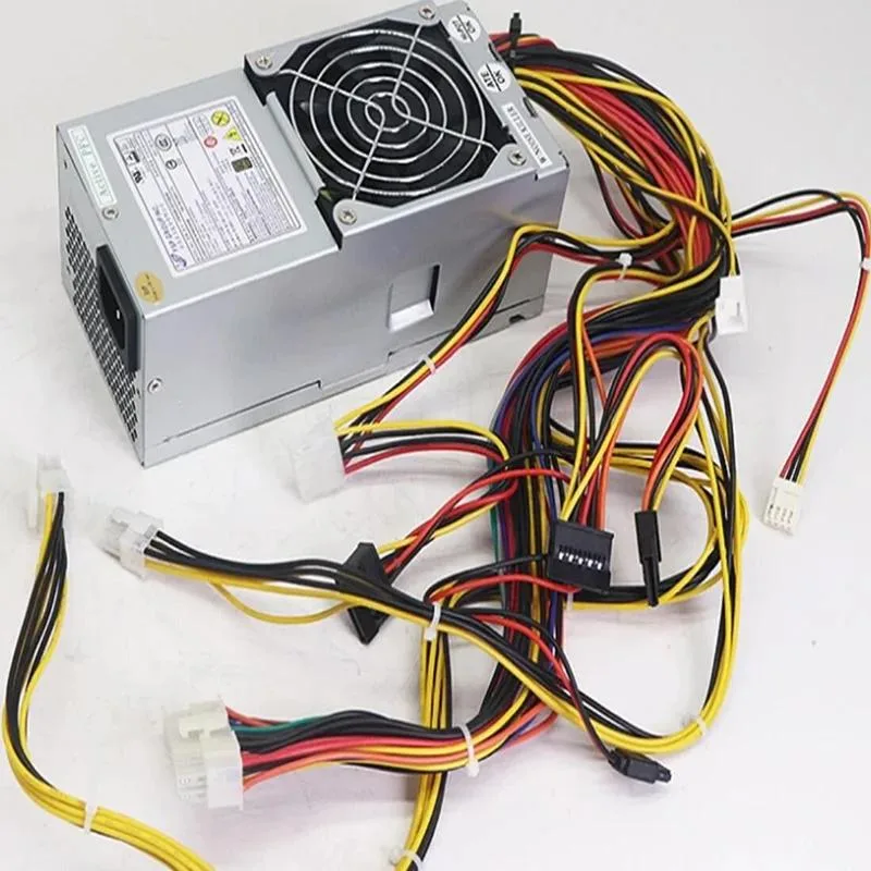 Small silver TFX power supply unit with fan grille and rear cable connectors