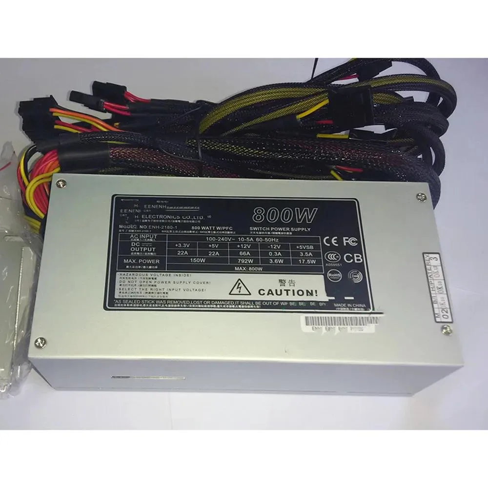 Silver 2U ATX power supply unit, rectangular metal chassis with rear fan grille and power socket