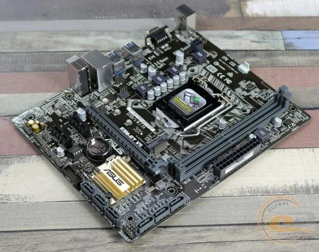 Green Micro ATX motherboard with silver CPU socket and black memory slots