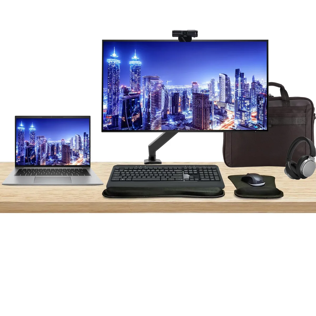 A silver 14-inch touchscreen laptop beside a 32-inch 4K monitor on an adjustable desk mount, with wireless keyboard, mouse, webcam