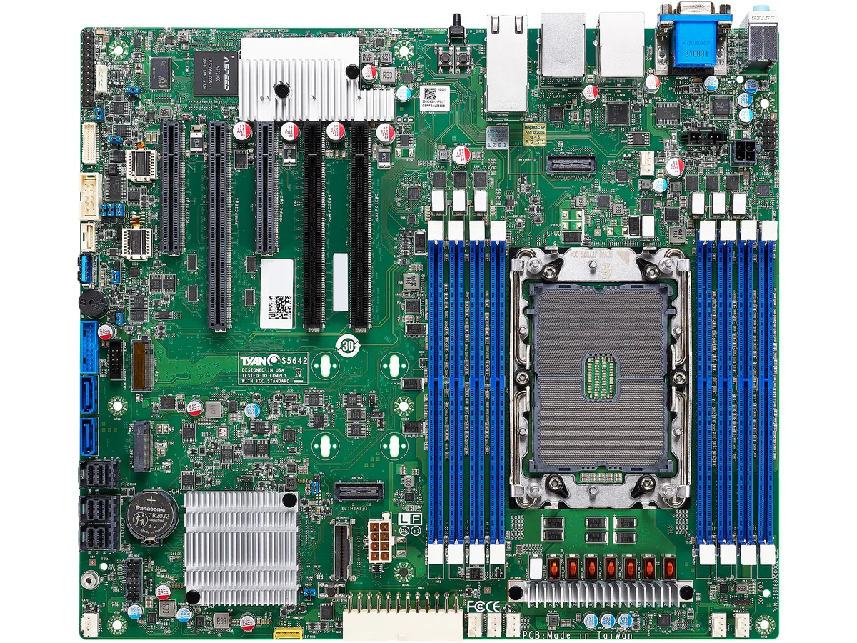 Green rectangular server motherboard with silver CPU socket, eight black memory slots and multiple PCIe expansion slots