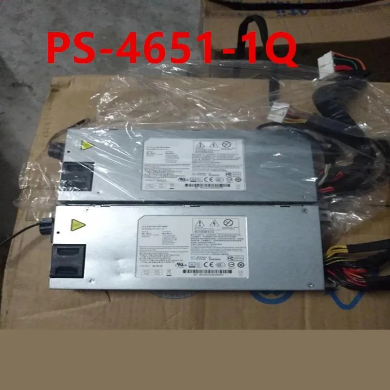 Rectangular black ATX power supply unit with fan grille and cable bundle