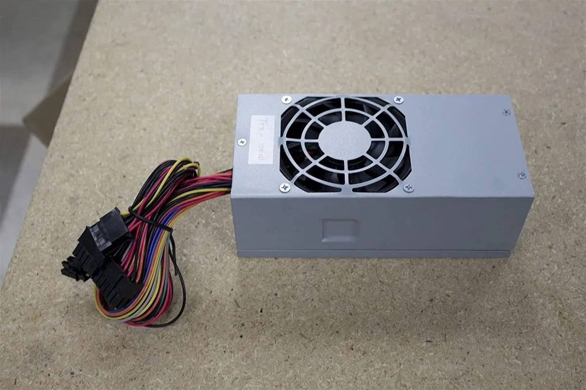 Compact TFX power supply unit with metal casing and rear fan grille