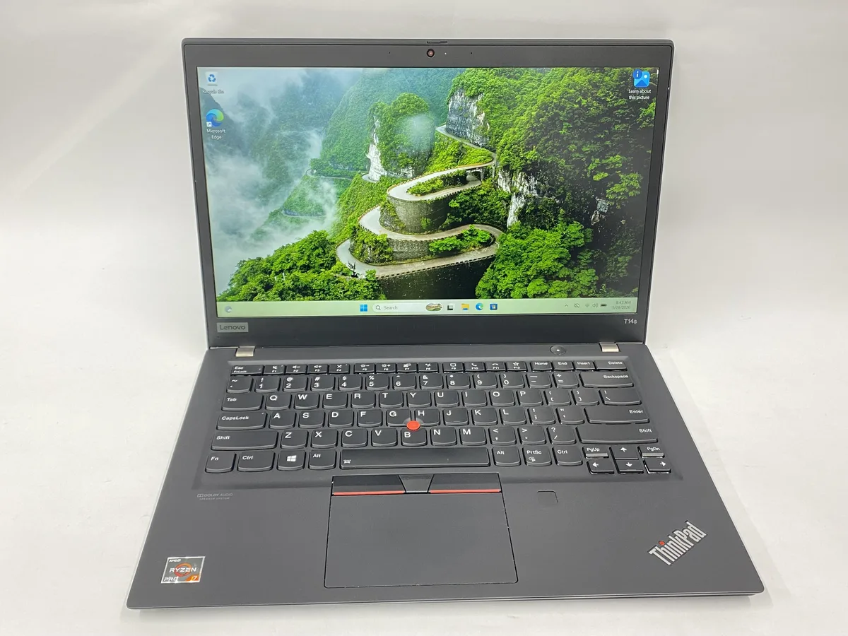 Slim silver 14 inch laptop with matte non-touch display and compact charger