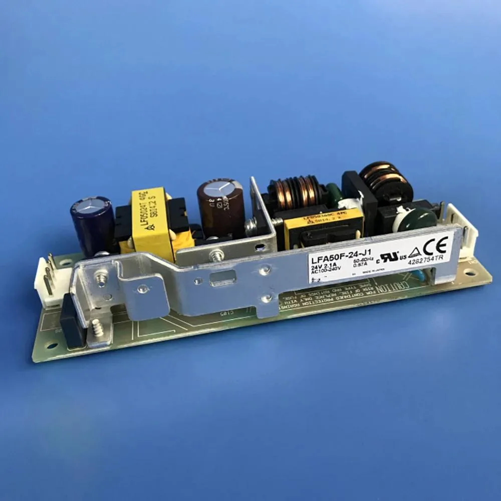 Rectangular metal ATX power supply unit with label showing 24V 2.1A 50W