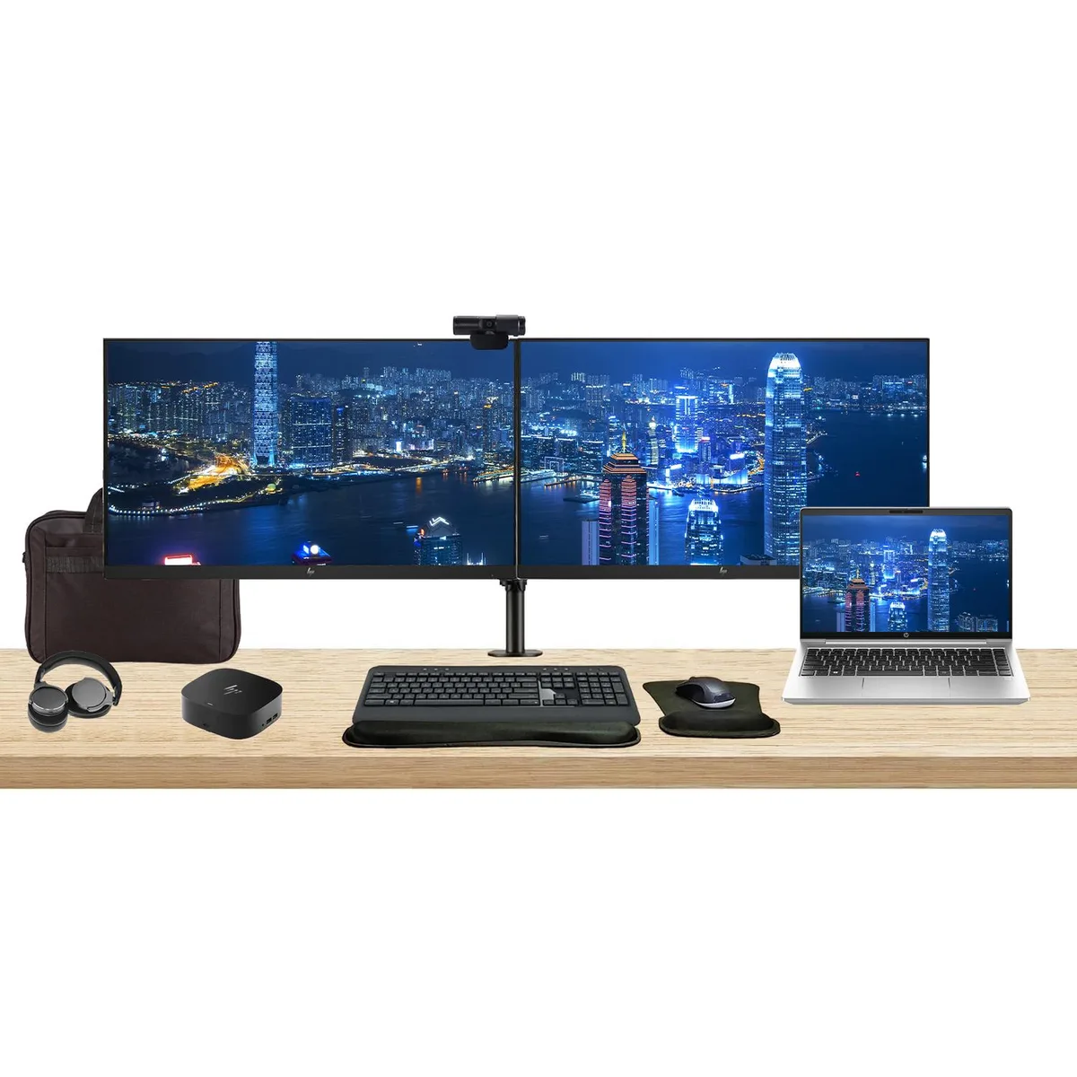 Silver 14-inch laptop, two 27-inch monitors on a dual stand, USB-C dock, wireless keyboard and mouse, webcam, headphones