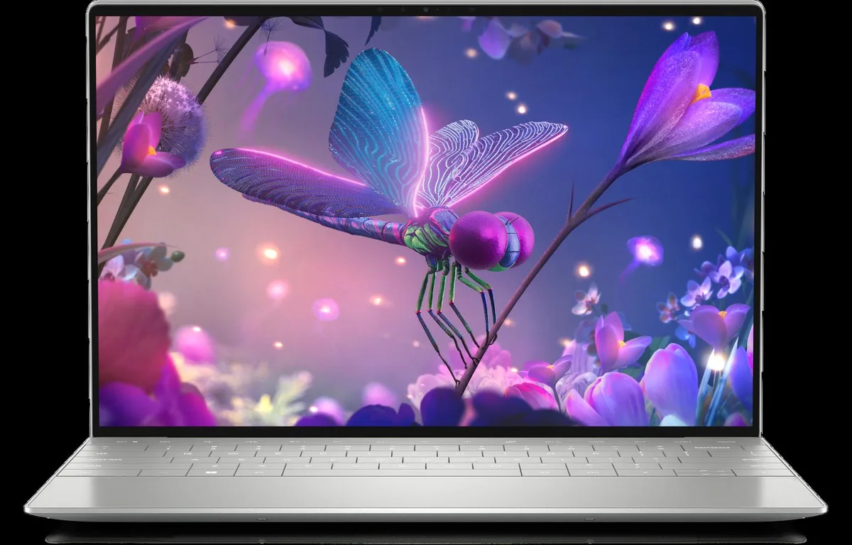 Silver ultra-thin laptop, edge-to-edge OLED touchscreen, zero-lattice keyboard, hidden haptic trackpad, two Thunderbolt 4 ports