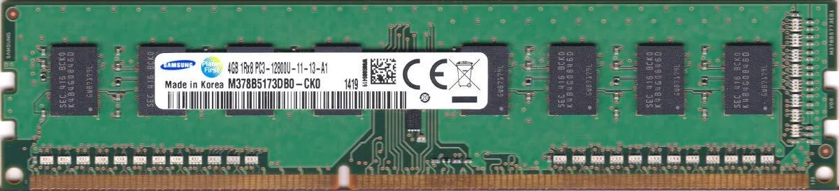 Green circuit board with black memory chips and gold edge connectors